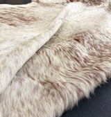 brown white cowhide rug